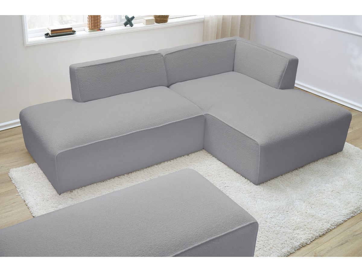 Canapé d'angle fixe modulable MEGEVE tissu bouclette avec pouf