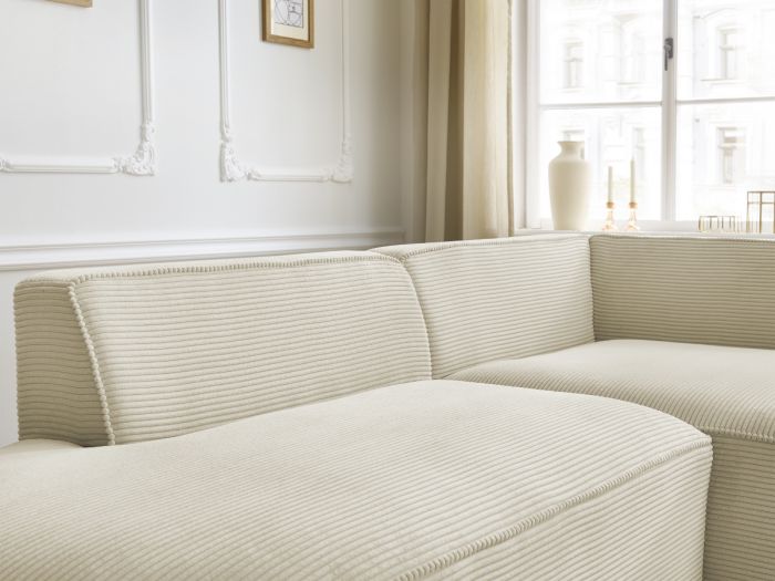 Gros plan des dossiers et coussins du canapé Rousseau beige, coutures visibles.