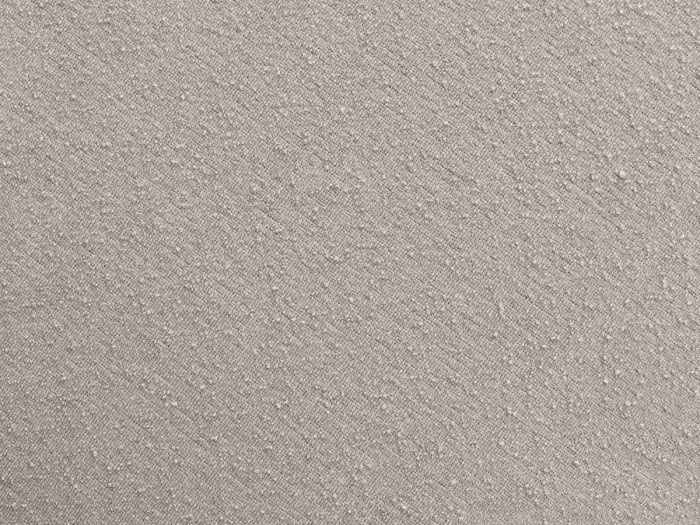 Gros plan sur la texture du tissu beige du canapé Zephyr, détail de la matière.