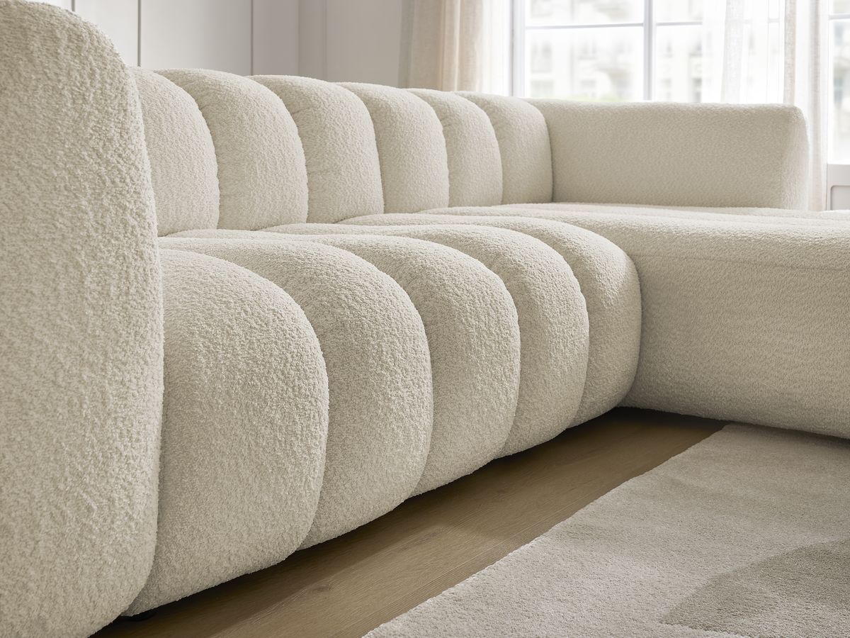 Canapé d'angle fixe TALIA tissu bouclette avec pouf