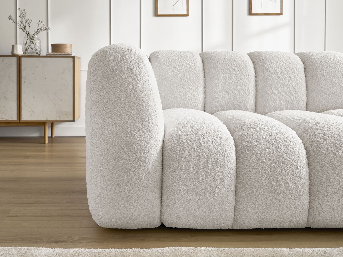 Canapé d'angle fixe TALIA tissu bouclette avec pouf