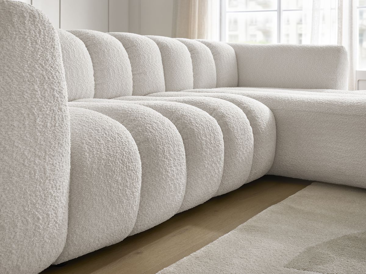 Canapé d'angle fixe TALIA tissu bouclette avec pouf