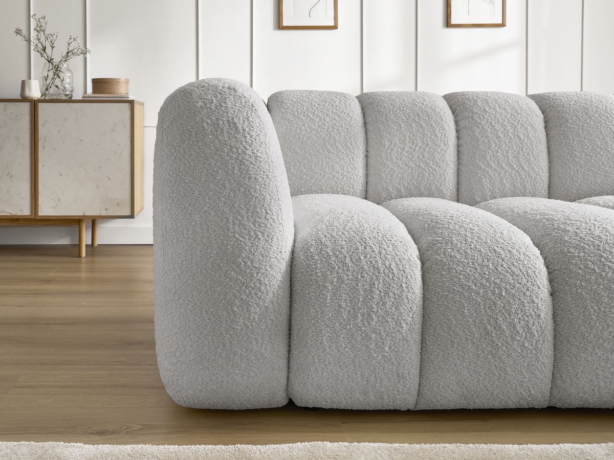 Canapé d'angle fixe TALIA tissu bouclette avec pouf