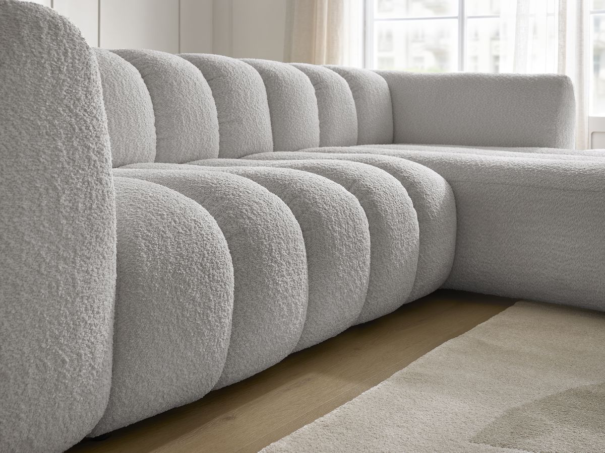 Canapé d'angle fixe TALIA tissu bouclette avec pouf