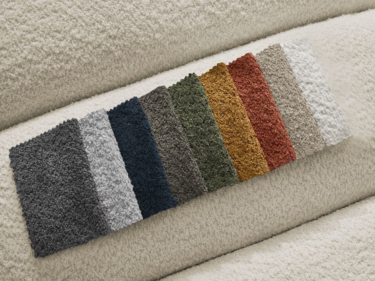 Canapé d'angle fixe TALIA tissu bouclette avec pouf