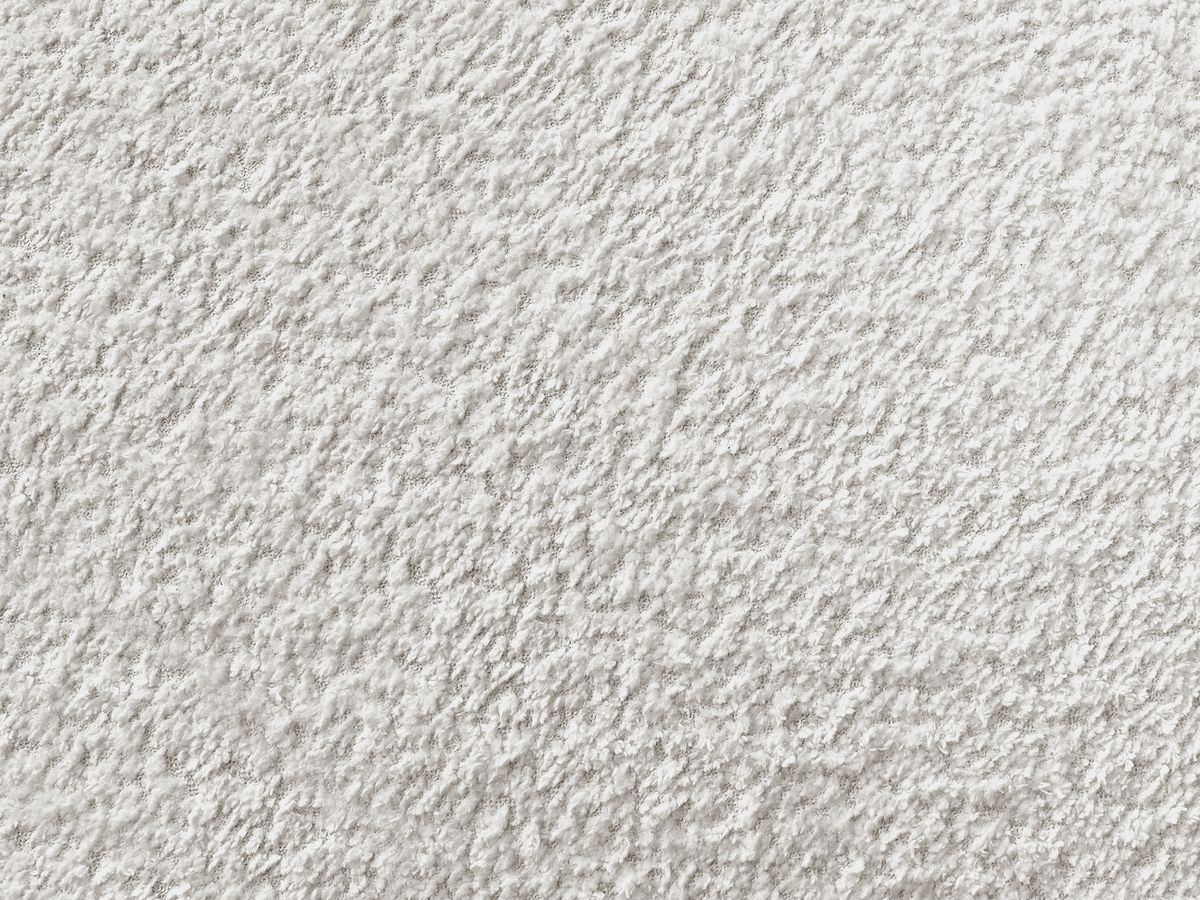 Canapé d'angle fixe TALIA tissu bouclette avec pouf