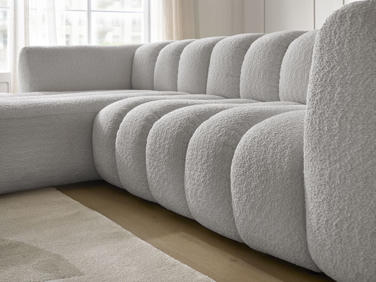 Canapé d'angle fixe TALIA tissu bouclette avec pouf
