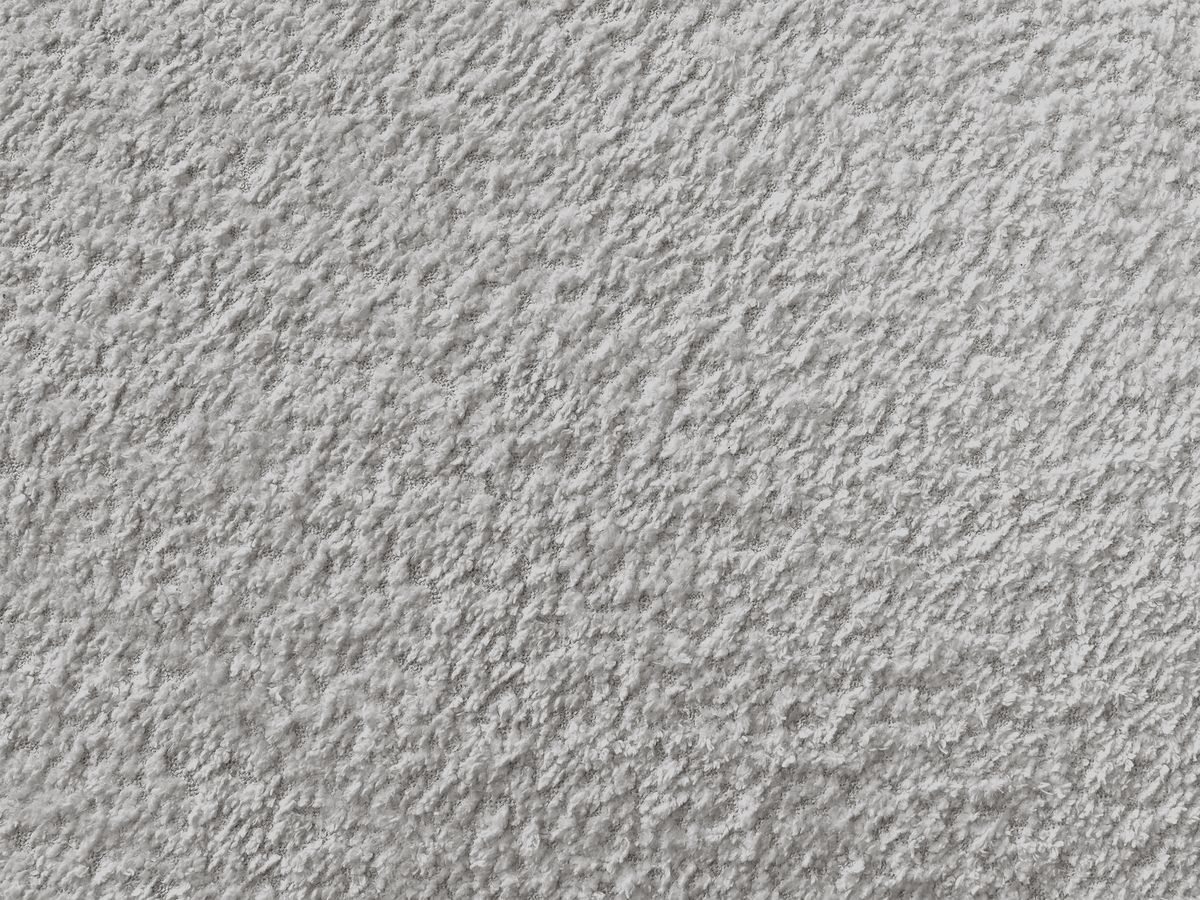 Canapé d'angle fixe TALIA tissu bouclette avec pouf