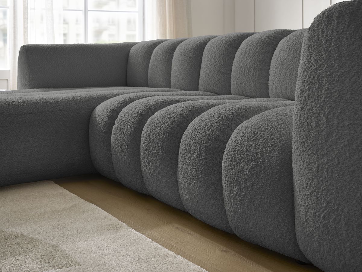 Canapé d'angle fixe TALIA tissu bouclette avec pouf