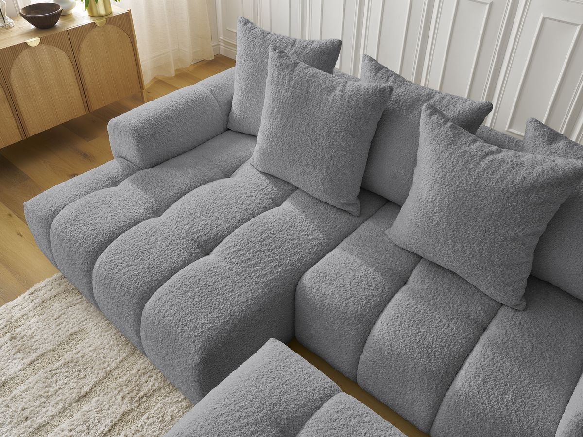 Canapé d'angle convertible coffre ROXELANE tissu bouclette avec pouf
