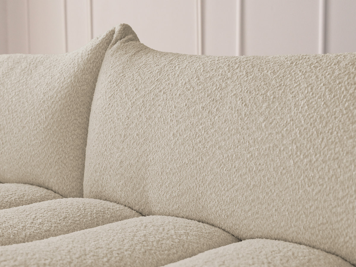 Canapé d'angle fixe modulable AZRA tissu bouclette avec pouf