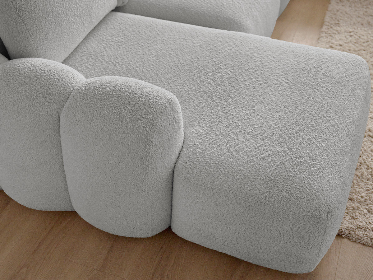 MONTAIGNE panoramische slaapbank met opbergruimte, bouclé stof en voetenbank.