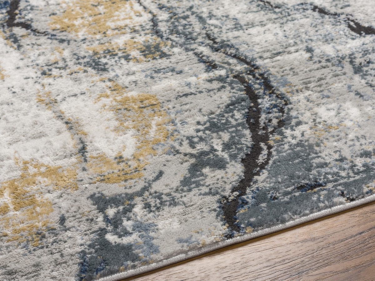 Rond vloerkleed van ALDA met korte pool en abstract patroon