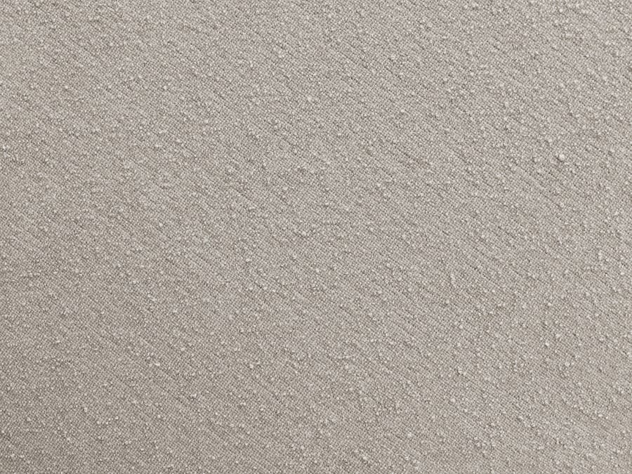 Gros plan sur la texture du tissu beige du canapé Zephyr, détail de la matière.