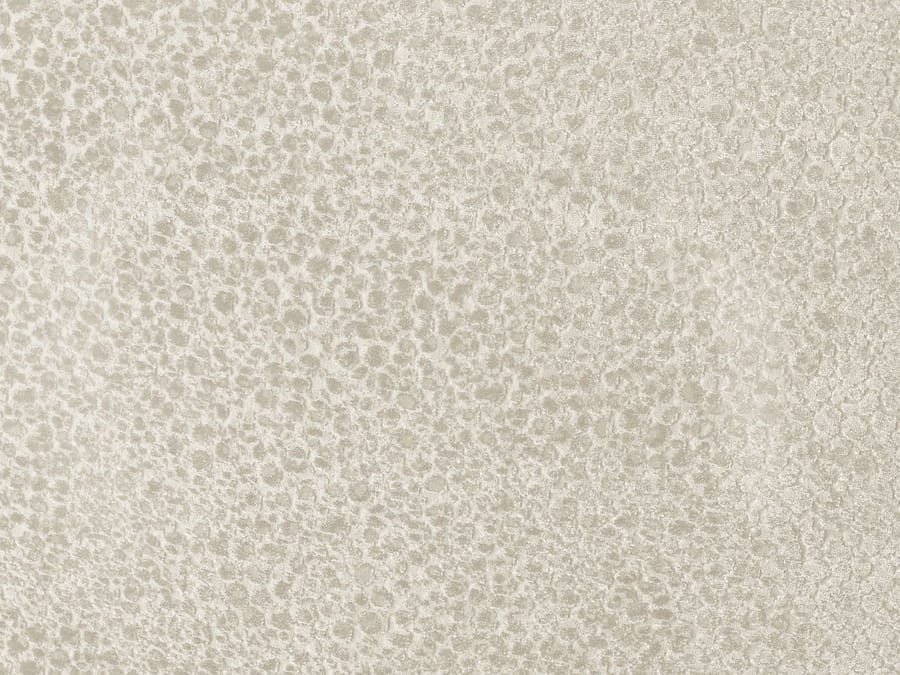 Gros plan sur la texture tissée du revêtement du canapé Celine beige.