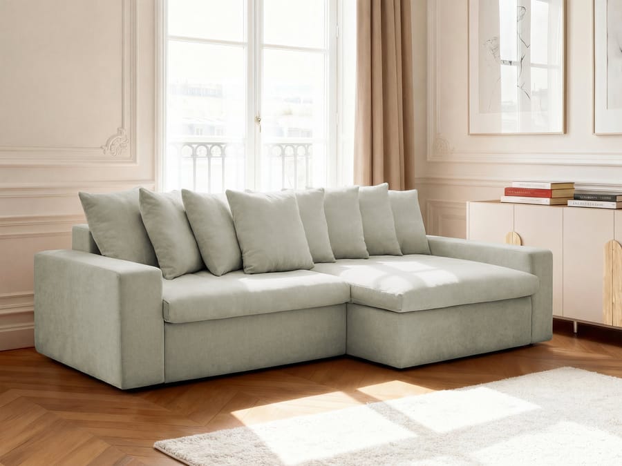 Canapé d'angle Enore beige installé dans un salon classique lumineux avec fenêtres.