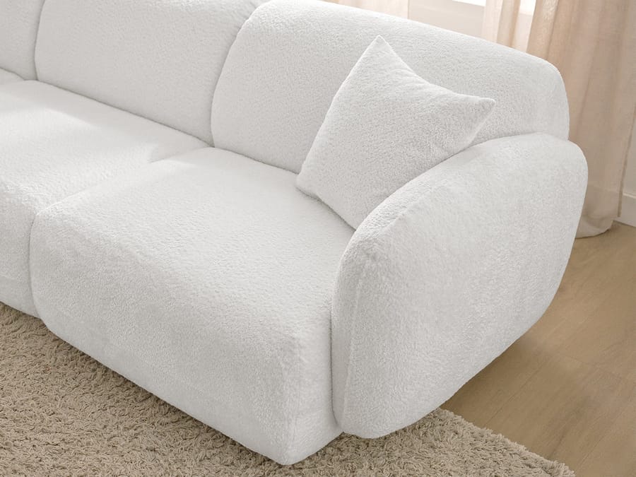 Canapé Anda blanc vue de profil, coin arrondi avec coussin, épaisseur visible