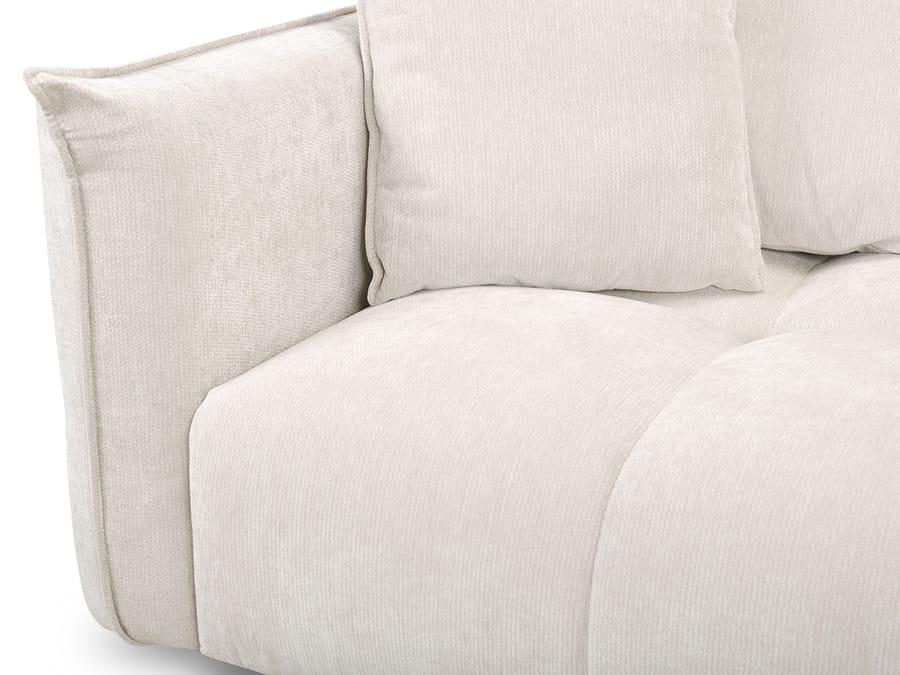 Gros plan des coussins et accoudoirs du canapé Harlem beige.