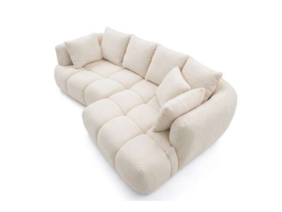 Canapé d'angle Aude beige clair, vue de côté montrant la profondeur et les accoudoirs.